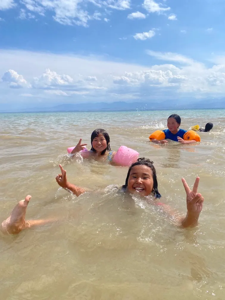 Children laughing while swimming in the lake